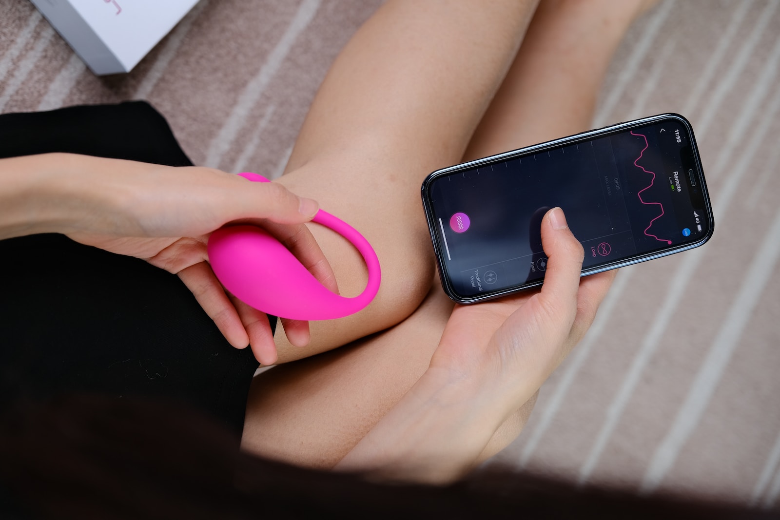 a woman holding a cell phone and a pink object
